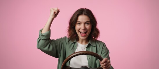 Cheering woman celebrating driving success, expressing happiness and confidence while holding a steering wheel, representing achievement after learning to drive