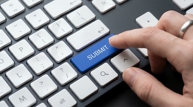 Close up of a human finger pressing the blue 'SUBMIT' key on a black computer keyboard indicating action and completion button enter technology data online digital communication click