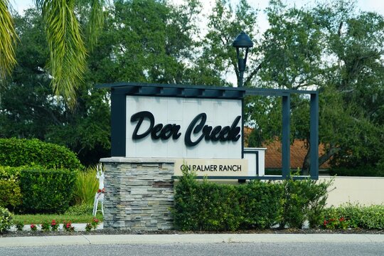 Sarasota County, Florida, U.S.A - Jan 4, 2026 - Elegant entrance sign marks Deer Creek community within Palmer Ranch, surrounded by lush landscaping and decorative elements.