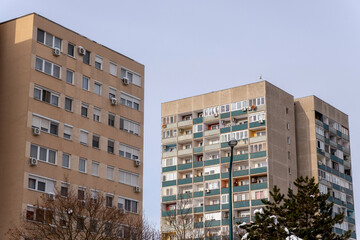 Buildings stand together in a city showing different styles of architecture and the effects of winter weather on a clear day