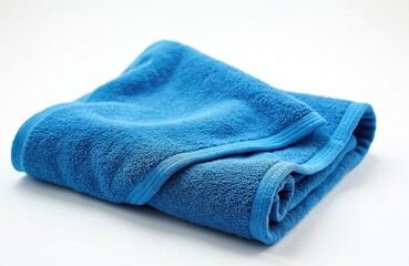 Fluffy blue towel folds on a white surface. Terrycloth bath towel isolated for hygiene. Cotton fabric close up details, soft texture on a bright clear backdrop in studio
