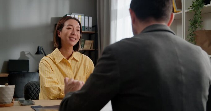 Businesswoman having meeting with client in office and signing contract