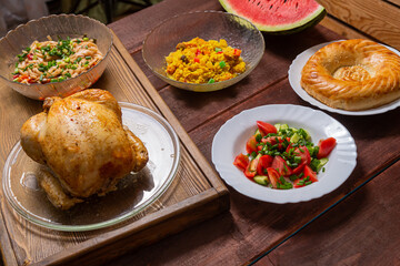 Couscous with dried fruits and turmeric, baked whole chicken flatbread