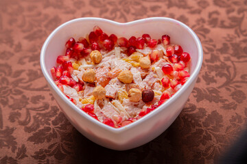 Chicken salad with pineapple and pomegranate in a heart shape