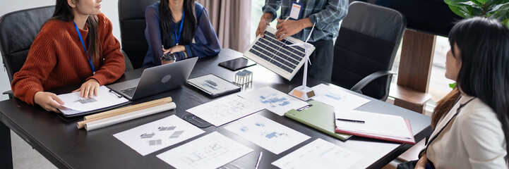 Solar panels green energy Business people working in green eco friendly office business meeting...