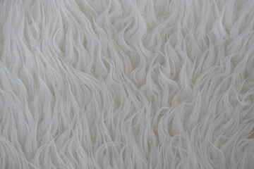 White shaggy faux fur texture background with soft fluffy hair © Florian Dussart