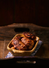 Fried chicken wings with potatoes on a rustic background. Soft focus.