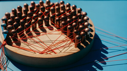 Metal spheres linked by tight, loose, and broken strings on a circular board visualize shifting alliances and fractured partnerships shaping 2026 geopolitical risk.