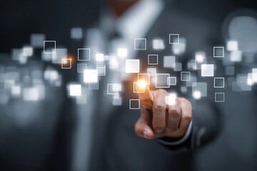 Man using touch screen technology in a business setting to interact with digital data squares
