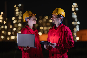 Engineers&rsquo; night shift working oil and gas refinery service, Workers hard work at night petroleum industry plant background.