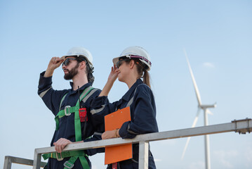 Engineers working on site in wind turbine farm, Wind turbines generate clean energy source, Eco technology for electric, industry environment.