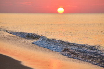 Sunrise Over a Calm Ocean Beach
