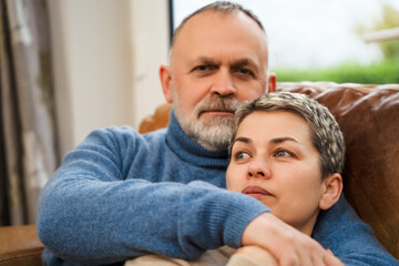 Couple enjoying time together at home in living room during a cozy afternoon moment