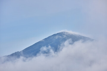 Mountain Peak Emerging Through Mist