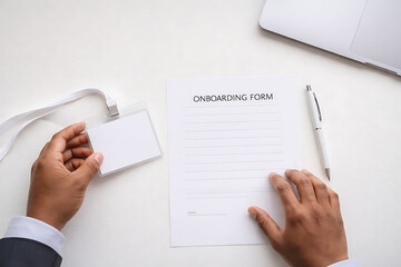 Businessman filling onboarding form with pen on desk