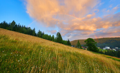 Rainbow Over Mountain Village Sunset