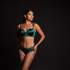 Fototapeta premium A graceful fashion elite woman with a magnificent figure poses in lingerie for a fashionable lingerie advertising photo shoot 