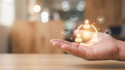Hand is extended with digital icons floating above it, symbolizing concepts like teamwork, communication, and technology. background is softly blurred, creating warm and inviting atmosphere