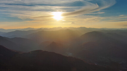 Obraz premium Flying over colorful foliage at sunset in mountains