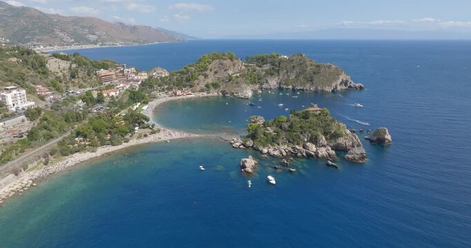 Aerial view of Isola Bella, a tidal island located on the eastern coast of Sicily, in province of Messina, Italy. It's a wonderful summer tourist destination.On the horizon, it's the Mediterranean Sea
