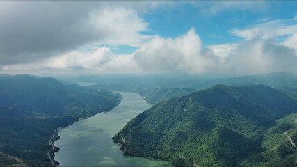 Aerial view on Danube river and mountains under clouds