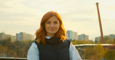 Young mother enjoys a sunny day at the park with her baby in a stroller