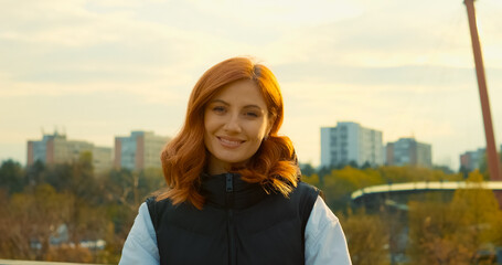Young mother enjoys a sunny day at the park with her baby in a stroller