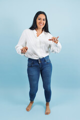 portrait of adult mexican woman dancing on blue background in Mexico Latin America, or Latina middle aged brunette female dancer