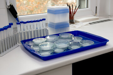 Microbiology laboratory equipment on a white table.