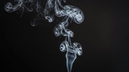 Wisps of white smoke rising against a stark, black background