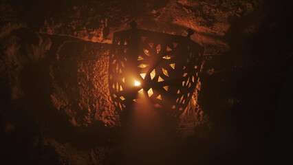 Old lantern with warm light rays in of old castle