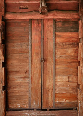 Closed old slide wooden door of rural vintage house. Vertical.