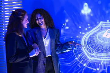 Medical researchers explaining neurology concepts to an audience. Two female scientists discussing human brain biology and biotechnology innovation next to a digital projection.