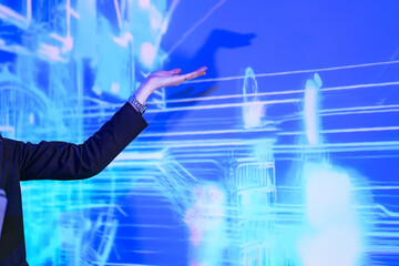 Innovative tech expert interacting with futuristic digital interface. Professional woman touching blue hologram circle on screen during high-tech presentation