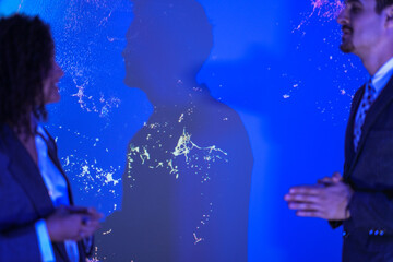 Corporate security experts discussing digital safety strategy. Business partners analyzing network protection and privacy lock concept in modern blue tech office.