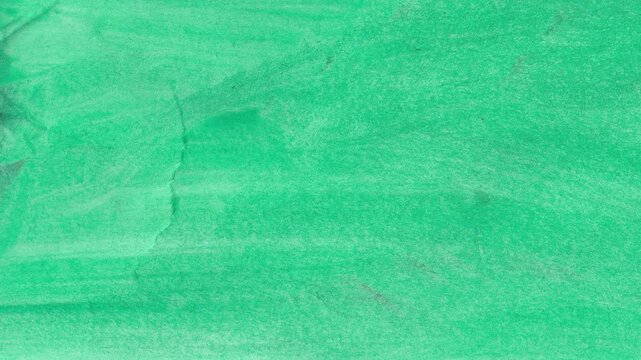 Abstract green wrinkled paper texture animation with realistic creases and folds, perfect for organic backgrounds, artsy overlays, and vintage style motion graphics projects.
