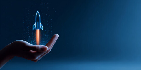 Hand holding glowing digital rocket icon with fiery trail on dark blue background symbolizing innovation and startup growth