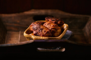 Fried chicken wings with potatoes on a rustic background
