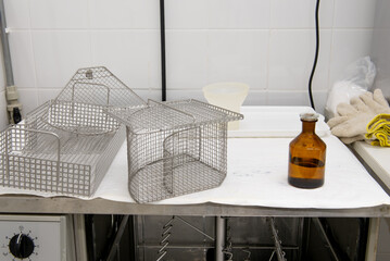 Laboratory dishwasher with baskets and laboratory bottle on top.