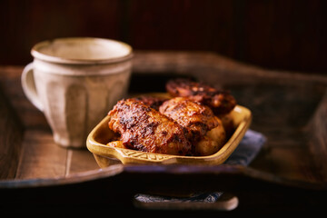 Fried chicken wings with potatoes on a rustic background
