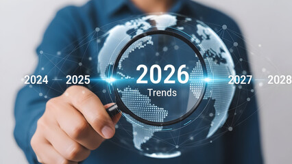 Businessman analyzing 2026 global trends with magnifying glass