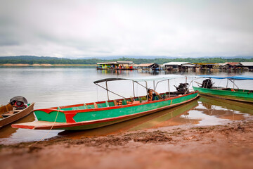 Many long -tail boats parked on the banks.