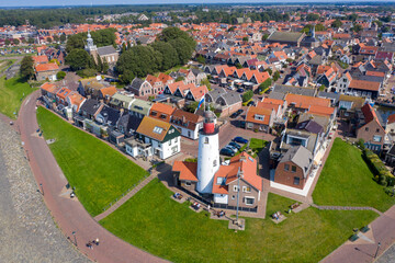 Drone photo of Urk village with the beautiful colorful lighthouse at the harbour by the lake ijsselmeer Netherlands Flevoland Europe