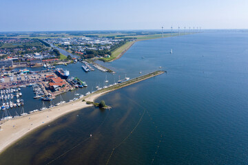 Drone photo of the former Zuiderzee island of Urk with beach harbors and old houses on a beautiful sunny day with cloudless sky