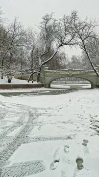Historic Stone Bridge in Snowy Bucharest Park, Winter Morning