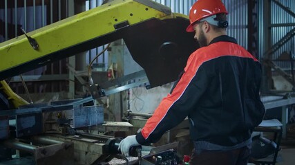 In front of the camera at the manufacture industrial zone factory worker working over the heavy machinery he wearing safety equipment and helmet - Powered by Adobe