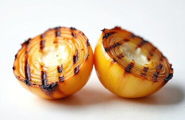 Grilled onion halves are delicious vegetarian food. Close up shot of grilled vegetables for healthy food. Onion halves with grill marks isolated on white background shows culinary art.