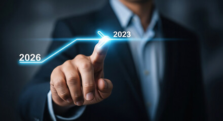 Businessman analyzing growth from 2023 to 2026 with glowing blue graph