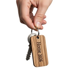 Home 2026 Real Estate Concept with Hand Holding House Keys on White Background