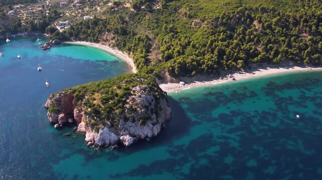 Stunning aerial view of unique double beach of Skopelos island - Stafylos and Velanio. Emerald sea with white pebles. Sporades, Greece 4k